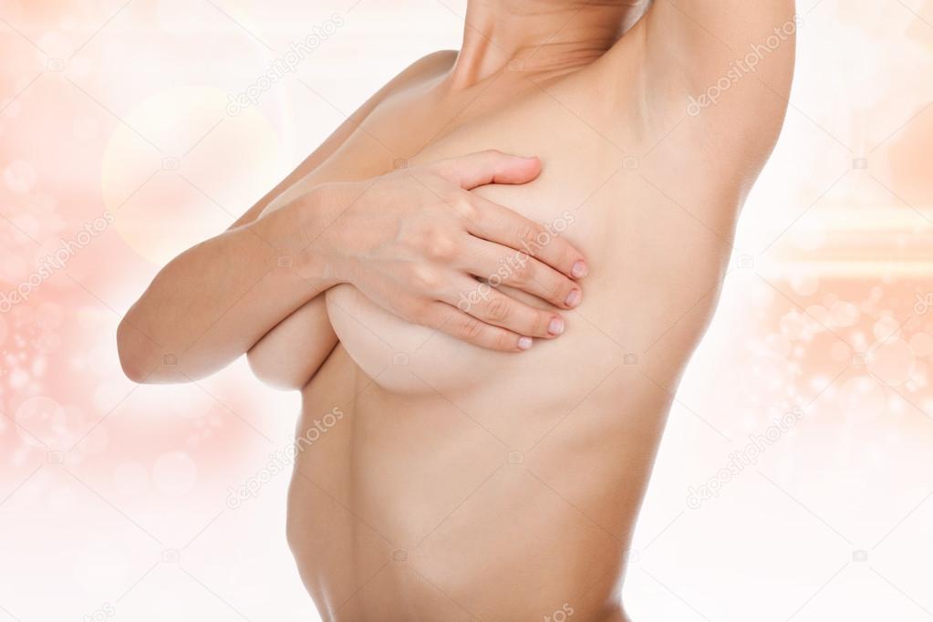 Woman examining her breast for lumps