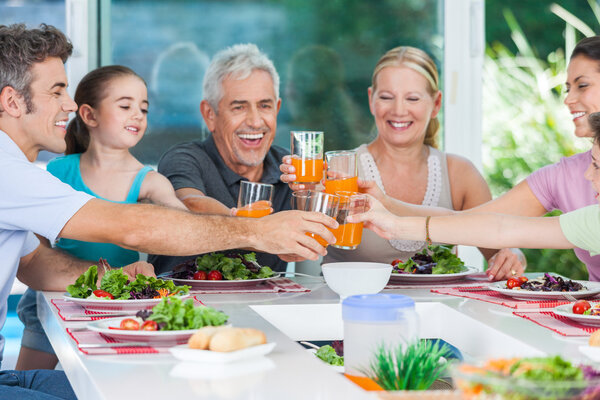 Big generation family drink orange juice