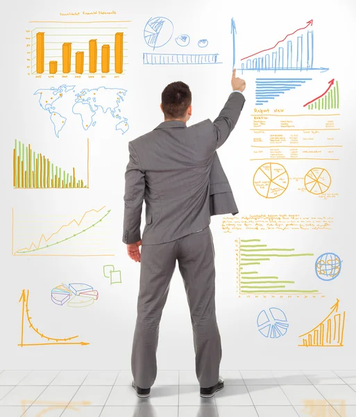 Businessman drawing finance graphs — Stock Photo, Image