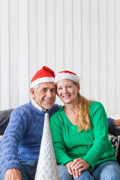 Senior couple wearing Santa  hats — Stock Photo, Image
