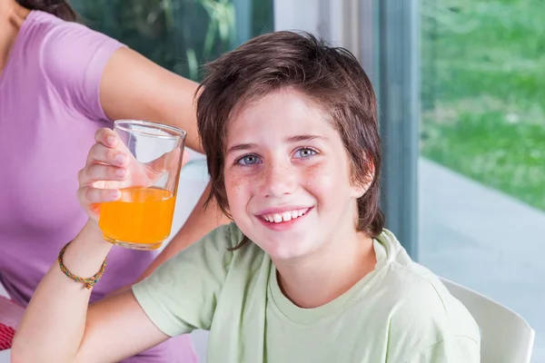 Boy drinking orange juice — Stock Photo, Image