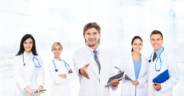 Medical team making welcome gesture Royalty Free Stock Images