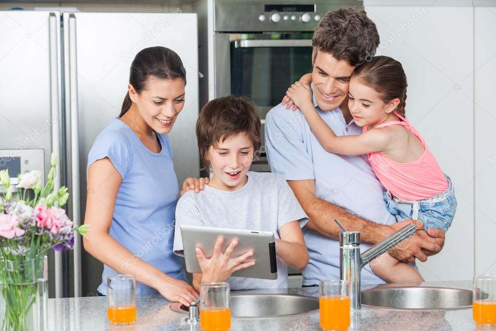 Family using a tablet pc in kitchen