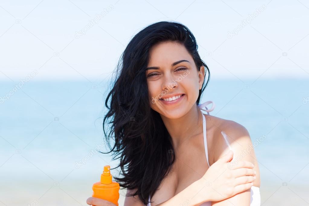 Woman apply sunscreen protection