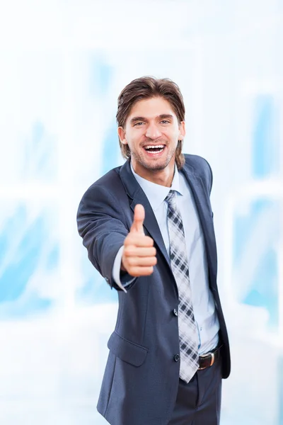 Business man holds thumb up — Stock Photo, Image