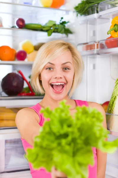 Woman holds green salad — Stock Photo, Image