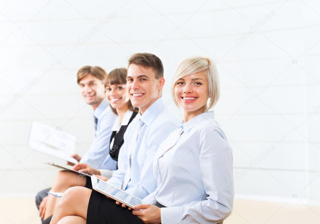 Three Mature Businesspeople Giving The Thumbs Up In An Office Stock Photo