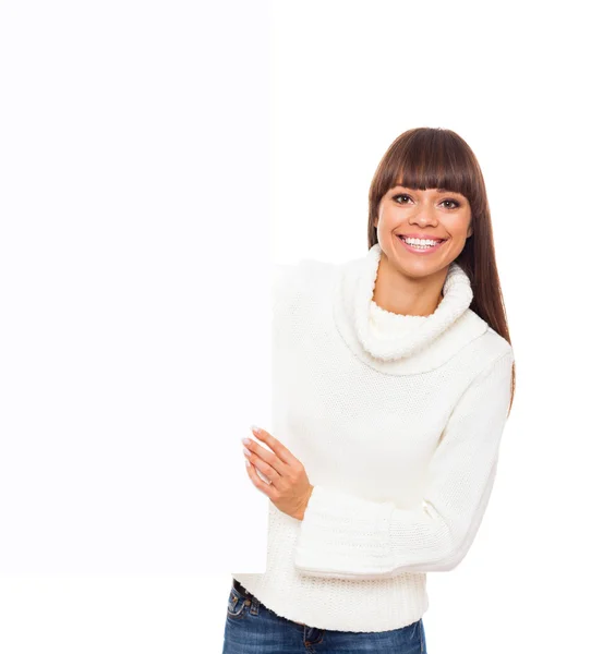 Woman holding blank board in sweater — Stockfoto