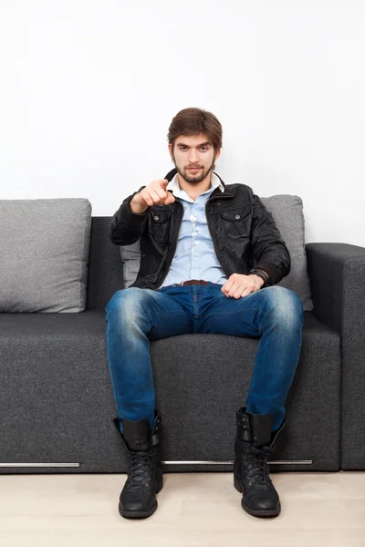 Man sitting on sofa pointing you — Stock Photo, Image