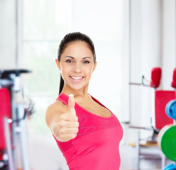 Fitness woman shows thumb up — Stock Photo, Image
