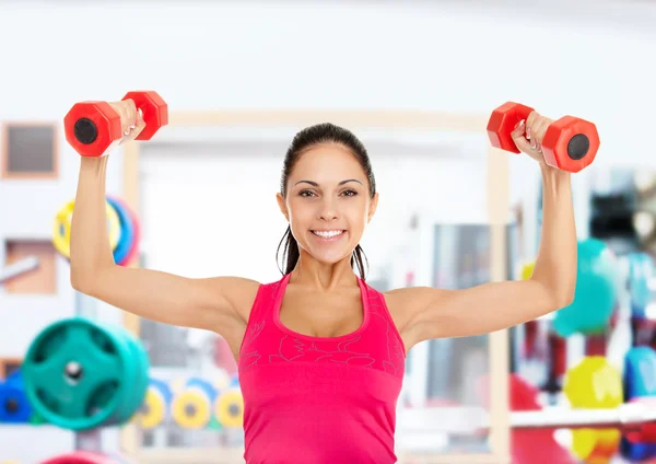 Girl doing exercises with dumbbells — Stock Photo, Image