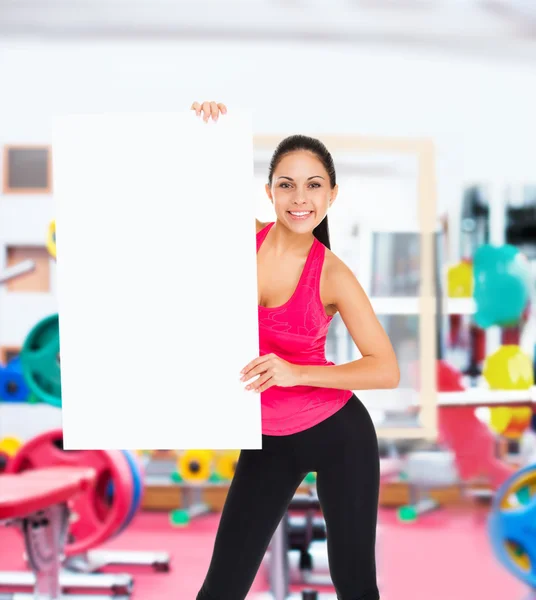 Fitness woman holds blank board — Stock Photo, Image