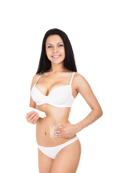 Woman applying moisturizer cream on belly — Stock Photo, Image