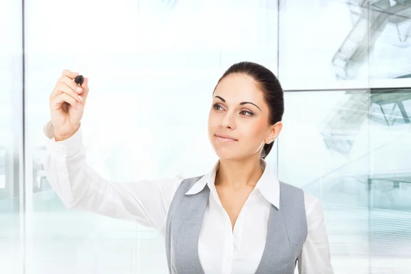 Businesswoman points with pen — Stock Photo, Image