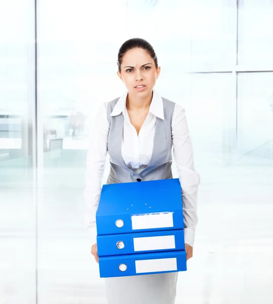 Tired businesswoman holding folder stack — Stock Photo, Image