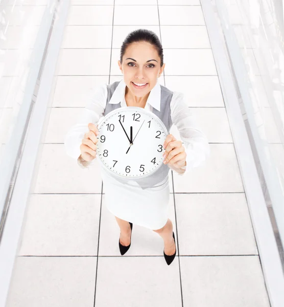 Businesswoman holding clock — Stock Photo, Image