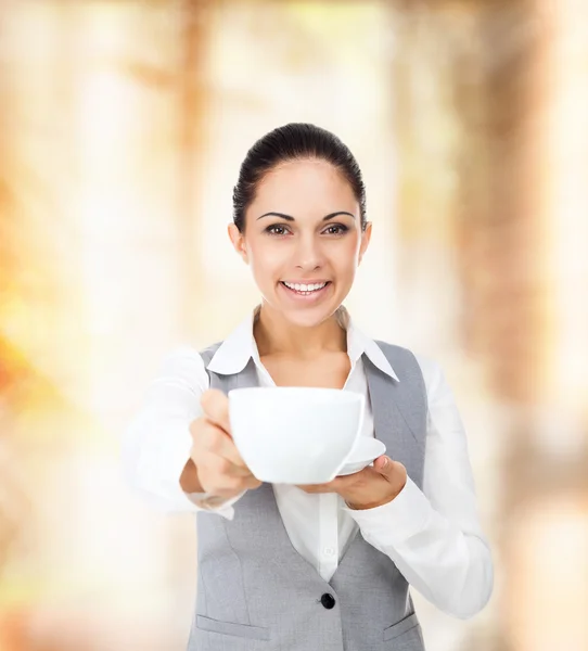 Business woman giving cup of coffee — Stock Photo, Image