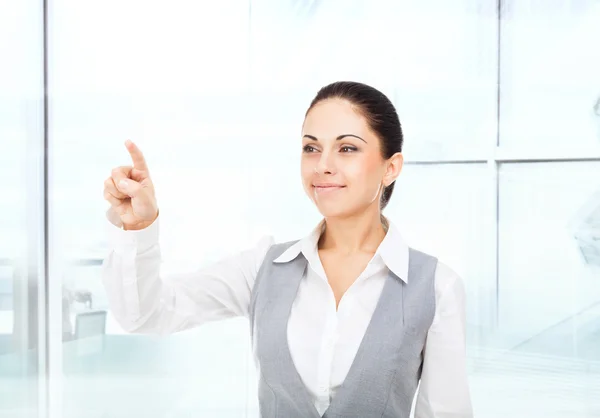 Smiling businesswoman points — Stock Photo, Image
