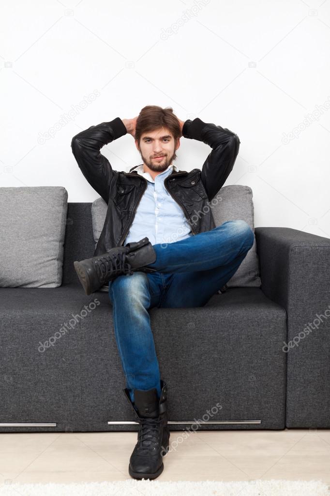 Man sitting on sofa in living room