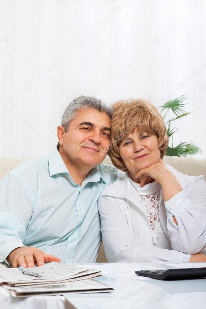 Senior couple sitting on sofa