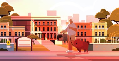 Kadın kedi ve köpekle yürüyor. Kadın sahibi ve evcil hayvanlarla eğleniyor.