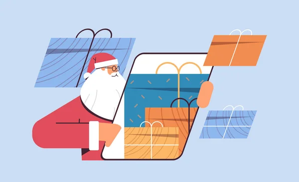 Santa Claus pomocí smartphone s dárky na obrazovce šťastný Nový rok Veselé Vánoce svátky koncepce — Stockový vektor