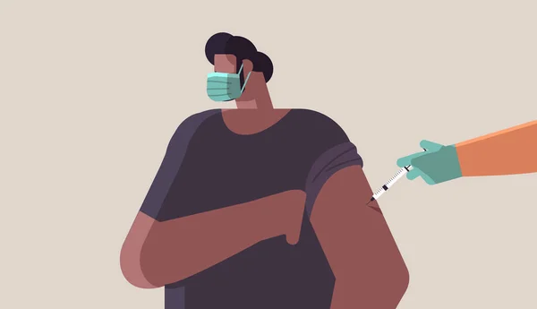 Medico mano vaccinare afro-americano paziente maschile in maschera medica lotta contro lo sviluppo del vaccino coronavirus — Vettoriale Stock