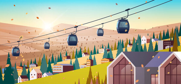 cableway in mountains residential houses area ski resort in autumn season sunset landscape background
