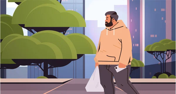 Человек с избыточным весом с покупками пластиковый пакет ходить по улице пешеходный переход городской пейзаж фоне — стоковый вектор