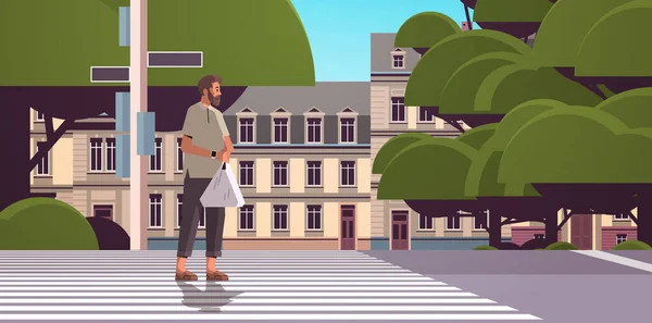 Homme avec sac en plastique marchant sur rue piéton passage piéton paysage urbain fond horizontal — Image vectorielle