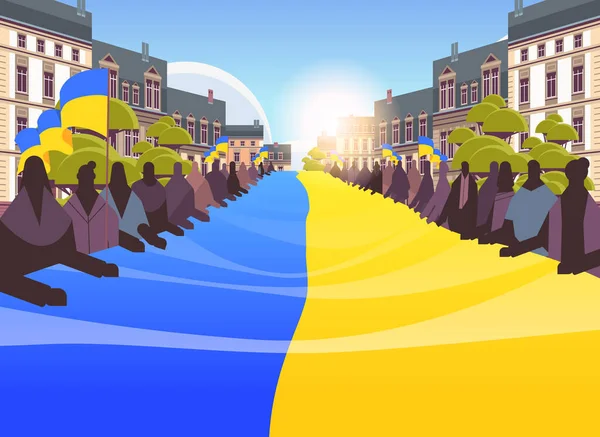 People silhouettes holding Ukrainian flag pray for Ukraine peace save Ukraine from russia stop war concept — ストックベクタ