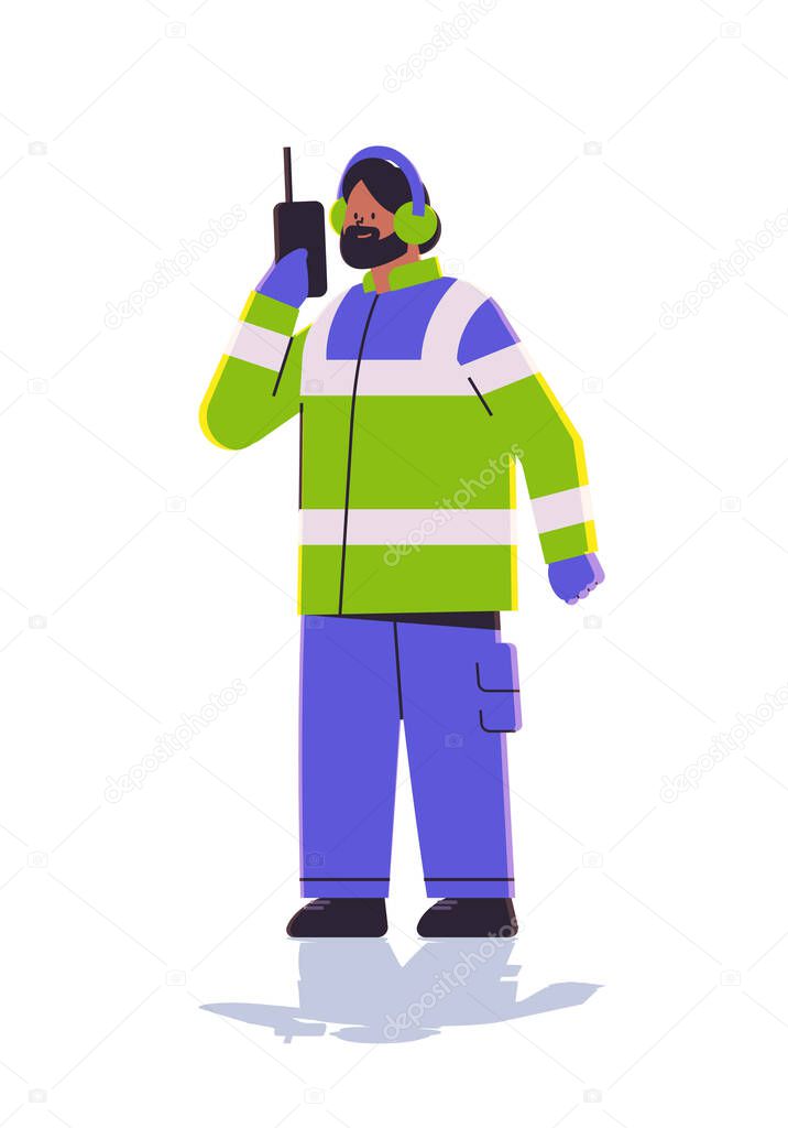 aviation marshaller in uniform using walkie talkie man air traffic controller airline worker in signal vest professional airport staff