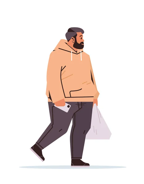 太りすぎの男がショッピングビニール袋を保持し 垂直方向のフル長さベクトルイラストを歩きながらスマートフォンを使用 — ストックベクタ