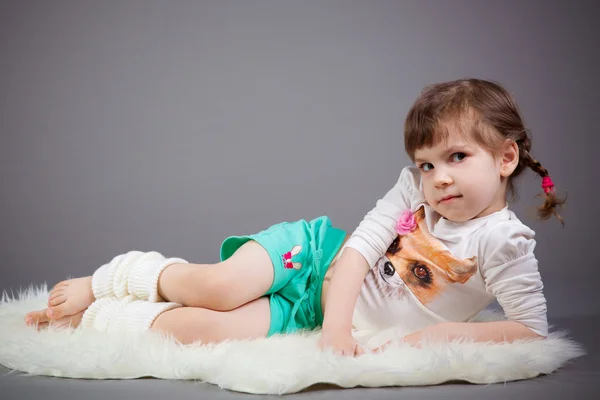 Little girl on gray background — Stock Photo, Image