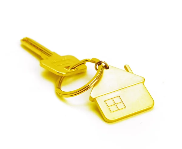 Zlatý dům klíč izolované na bílém — Stock fotografie