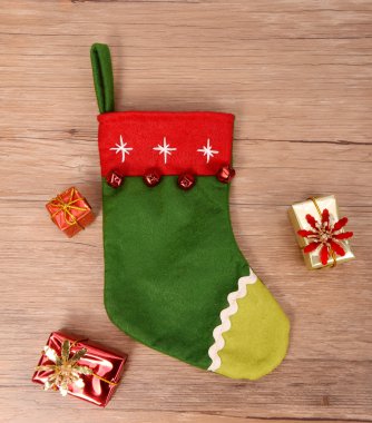 Noel çorabı ve tahta arka planda hediyeler