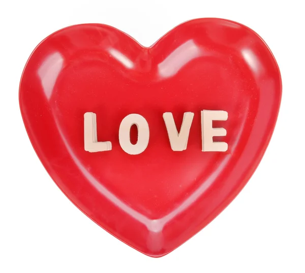 Αγάπη ξόρκι με ξύλινα μπλοκ αλφάβητο στο πιάτο σχήμα καρδιά — Φωτογραφία Αρχείου