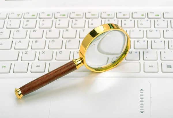 Laptop with a magnifying glass — Stock Photo, Image
