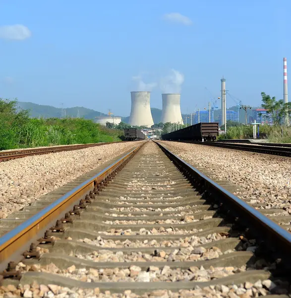 Industrial landscape with chimneys and train — Stock Photo, Image