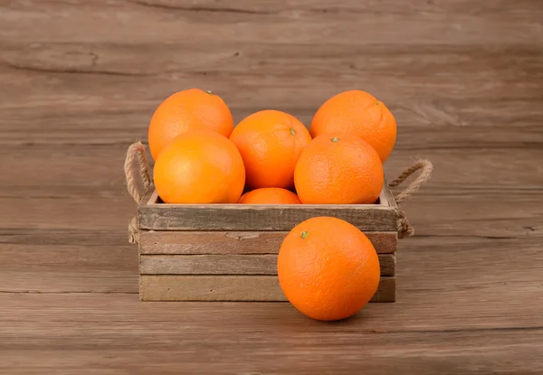 Fresh oranges in wooden box — Stock Photo, Image