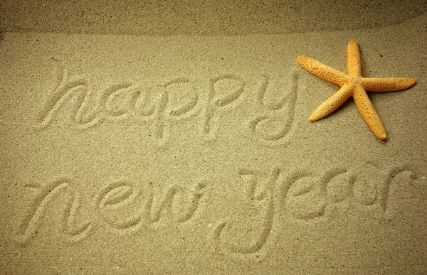 Happy new year written in the sand — Stock Photo, Image