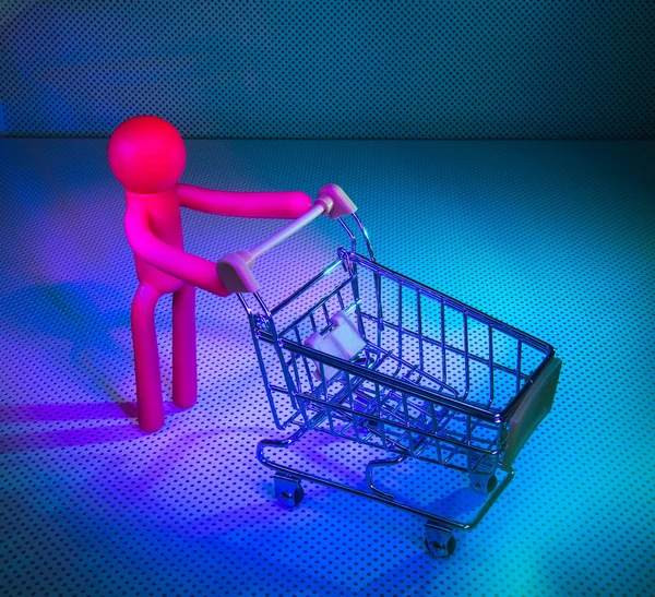 Rubber Figures with a shopping cart — Stock Photo, Image