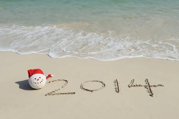 Jahr 2014 handgeschrieben auf dem weißen Sand vor dem Meer — Stockfoto