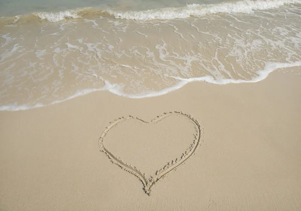 Handwritten heart on sand Stock Picture