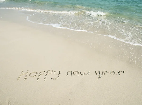 Happy new year written in the sand — Stock Photo, Image