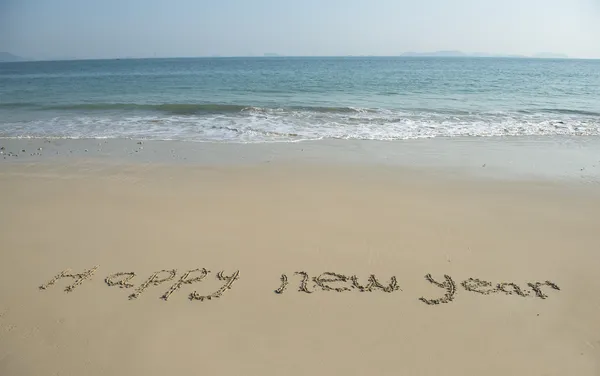 Happy new year written in the sand — Stock Photo, Image