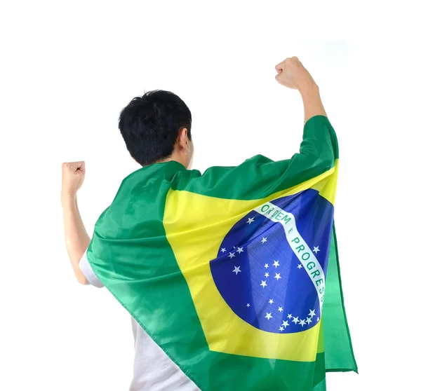 Бразилец празднует с флагом и маской — стоковое фото