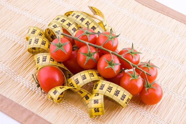 Tomatoes and tailor tape — Stock Photo, Image