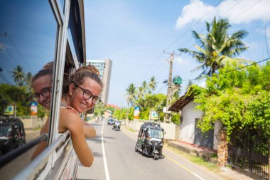 Mutlu kız Sri Lanka 'da yerel bir otobüse biniyor.