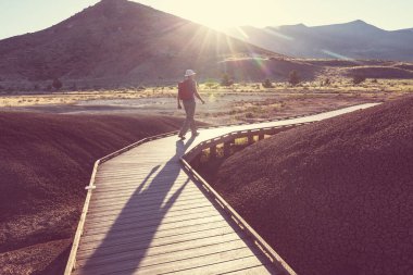 Man hiking in John Day Fossil Beds National Monument, Oregon, USA. Unusual natural landscapes.